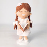 BibleGirl is the adorable plush girl doll that speaks 36 Bible verses. Holds her Bible with magnets in her hands and in the Bible. Wholesome dress. Beautiful braids with bows and a flower in her hair. Perfect gift idea for Christian girls. From Jesusdoll.com.